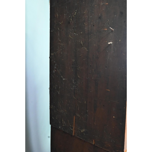 1028 - A Georgian oak corner cupboard, in two parts, the upper with broken swan-neck pediment over a pair o... 