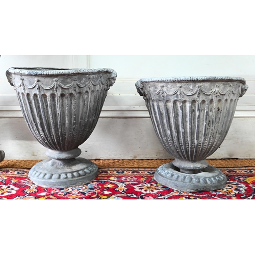 1036 - An antique pair of Adam style lead urns, 37 cm h (2)