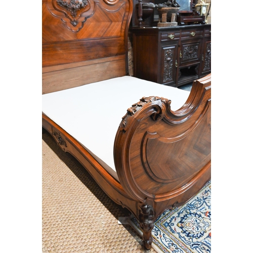 1045 - An antique French kingwood bedstead, with mattress + base (marks to mattress) 200 cm x 172 cm, the h... 