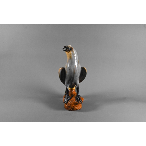 500 - A late 19th or early 20th century Japanese earthenware falcon with variegated purple and brown lead ... 