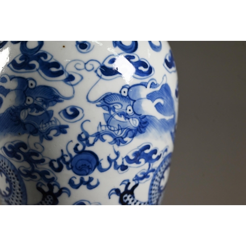 525 - A 19th century Chinese blue and white 'dragon' vase and domed cover with moulded guardian lion finia... 