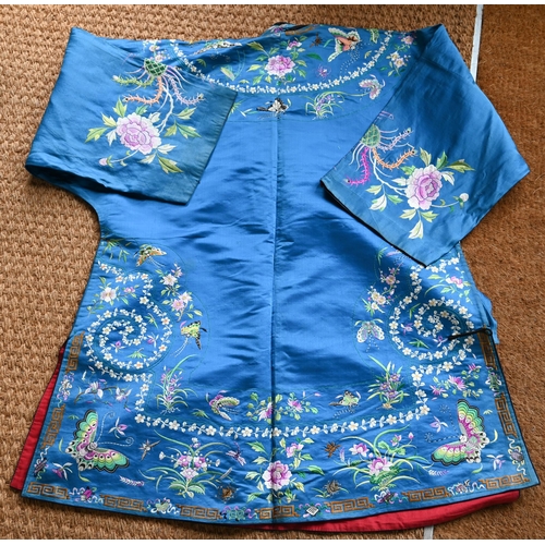 530A - A 20th century traditional Chinese silk robe and jacket, embroidered with floral designs, figural ro... 
