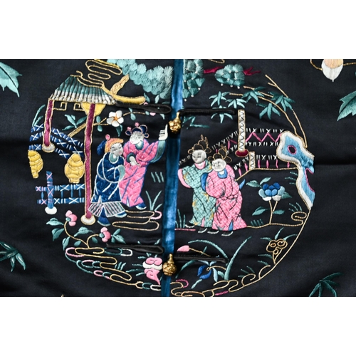 530A - A 20th century traditional Chinese silk robe and jacket, embroidered with floral designs, figural ro... 