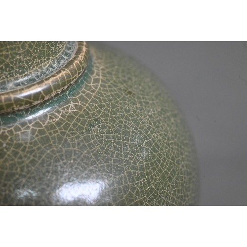 531 - A Chinese globular vase with flared neck and everted foliate rim, covered overall with an opaque cra... 