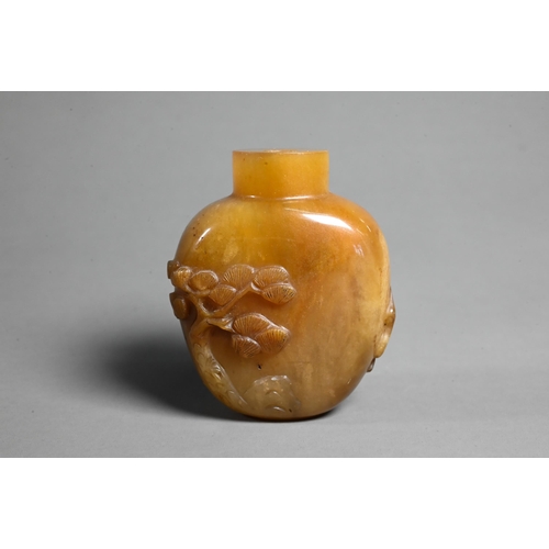 544 - A Chinese butterscotch agate snuff bottle, carved in relief with a sage, deer, crane and pine tree -... 