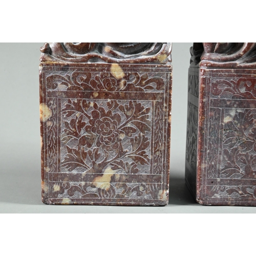 548 - A pair of early 20th century Chinese carved and engraved soapstone bookends, red stone with buff inc... 
