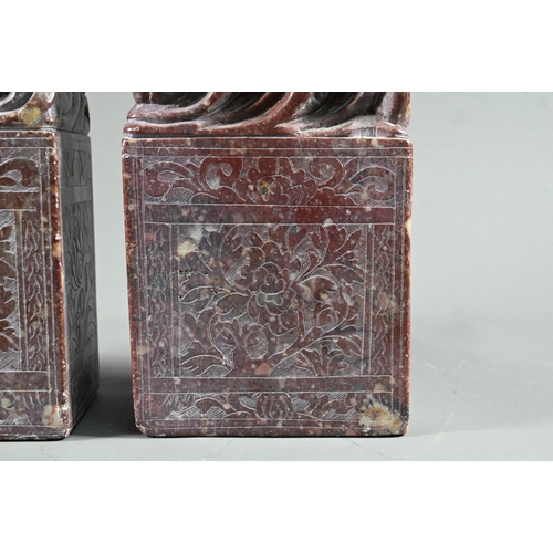 548 - A pair of early 20th century Chinese carved and engraved soapstone bookends, red stone with buff inc... 