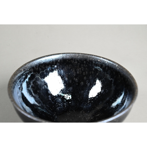 560 - A Chinese Jianyao 'oil spot' bowl in the Song Dynasty style, covered in a thick unctuous black glaze... 