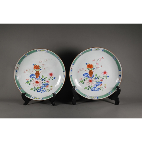 564 - A pair of 18th century famille rose shallow bowls, painted with floral designs in polychrome enamels... 