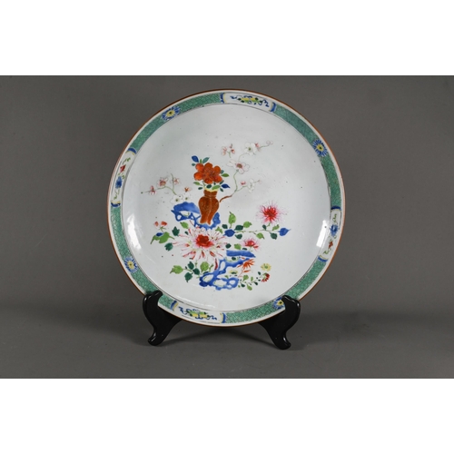 564 - A pair of 18th century famille rose shallow bowls, painted with floral designs in polychrome enamels... 