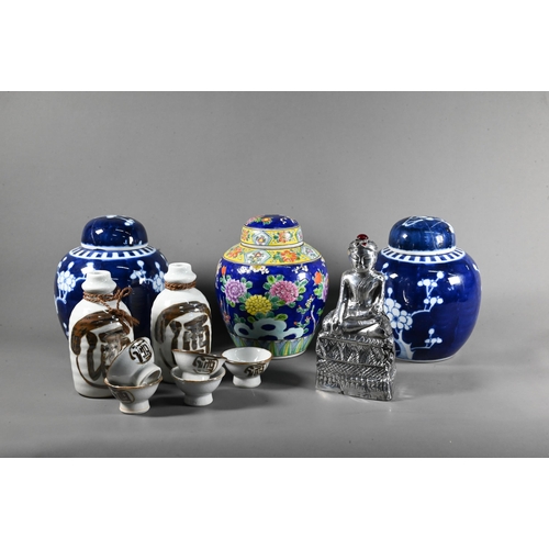 575 - A pair of 20th century Chinese blue and white prunus on cracked ice ginger jars and covers, 15 cm hi... 