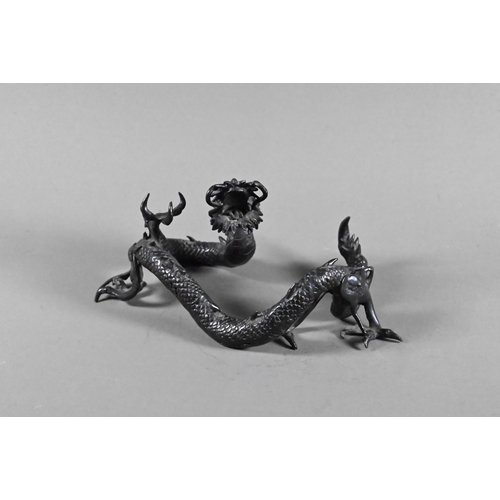 579 - A Chinese bronze three-clawed Mizuchi Dragon, modelled with long scaly, sinuous body and fierce expr... 