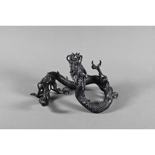 579 - A Chinese bronze three-clawed Mizuchi Dragon, modelled with long scaly, sinuous body and fierce expr... 