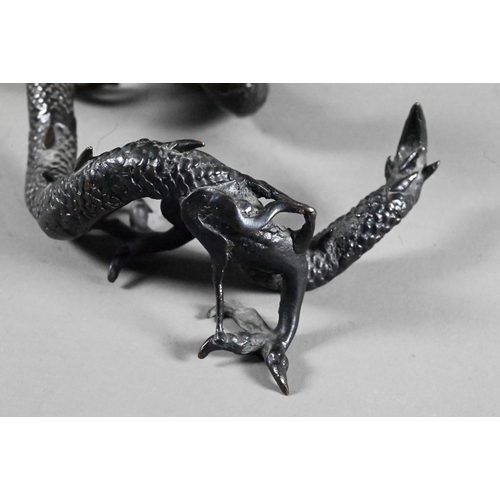 579 - A Chinese bronze three-clawed Mizuchi Dragon, modelled with long scaly, sinuous body and fierce expr... 