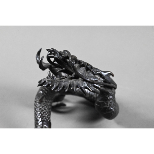 579 - A Chinese bronze three-clawed Mizuchi Dragon, modelled with long scaly, sinuous body and fierce expr... 