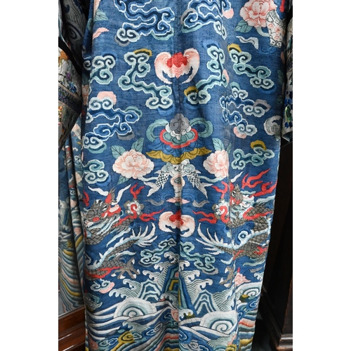 593 - A Chinese blue gauze brocade-woven dragon robe, late Qing period, woven design with nine dragons amo... 