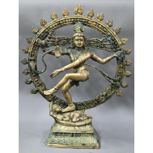 594 - A large Indian brass figure of Shiva Nataraja, the four-armed Hindu god holding a damuru drum and ag... 