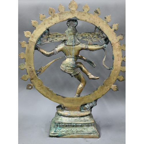 594 - A large Indian brass figure of Shiva Nataraja, the four-armed Hindu god holding a damuru drum and ag... 