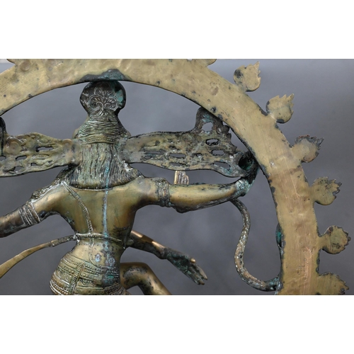 594 - A large Indian brass figure of Shiva Nataraja, the four-armed Hindu god holding a damuru drum and ag... 