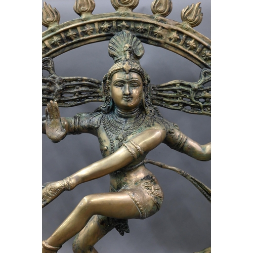 594 - A large Indian brass figure of Shiva Nataraja, the four-armed Hindu god holding a damuru drum and ag... 