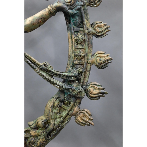 594 - A large Indian brass figure of Shiva Nataraja, the four-armed Hindu god holding a damuru drum and ag... 