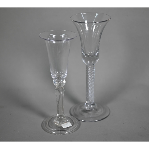 611 - A Georgian drinking glass, the elongated bowl with flared rim, on baluster stem with folded foot-rim... 