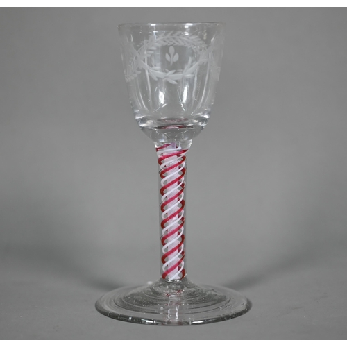 613 - A Georgian cordial glass cut with intertwined foliated guilloches, on red/white opaque triple-twist ... 