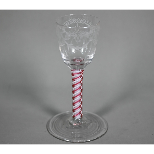 613 - A Georgian cordial glass cut with intertwined foliated guilloches, on red/white opaque triple-twist ... 