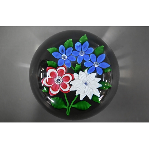 614 - A modern Saint-Louis (France) glass paperweight with floral specimen, 1986 dated on cane, 8cm diam