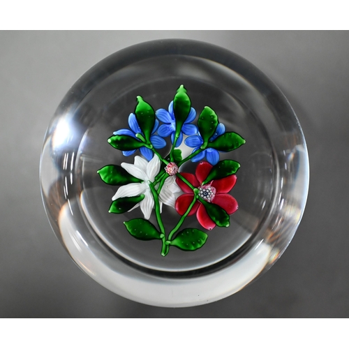 614 - A modern Saint-Louis (France) glass paperweight with floral specimen, 1986 dated on cane, 8cm diam