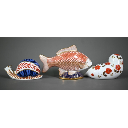 628 - Two Royal Crown Derby figures, snail and Fish, to/w three paperweights with silver plugs: Frog, Seal... 