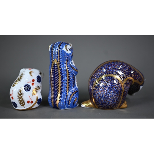 629 - A Royal Crown Derby Hedgehog paperweight with gold plug, four other paperweights with silver plugs: ... 