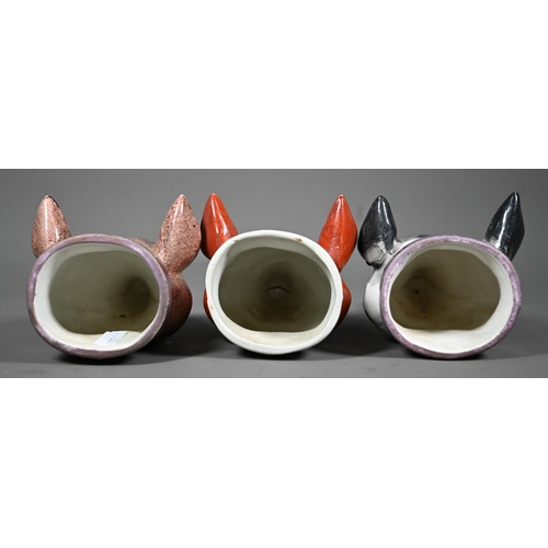 632 - Two early 19th century Pratt-type pottery fox's head stirrup cups with pink lustre collars, to/w a s... 