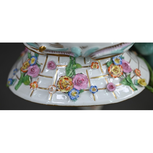 636 - A pair of 19th century Meissen bonbon dishes modelled as floral painted and encrusted baskets held b... 