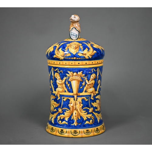 644 - A Venetian maiolica tankard & cover, painted with grotesques and putti in ochre and yellow on a ... 