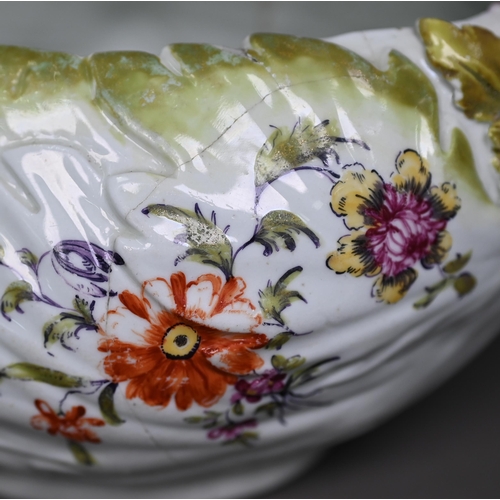 650 - A Chelsea Derby porcelain leaf-moulded sauce-boat with applied floral decoration, organic handle and... 