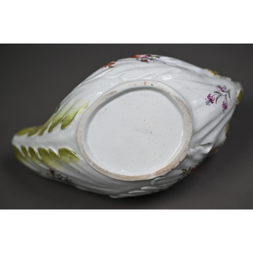 650 - A Chelsea Derby porcelain leaf-moulded sauce-boat with applied floral decoration, organic handle and... 