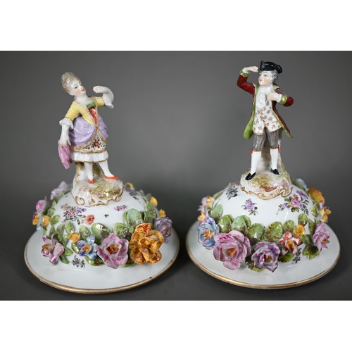 668 - A good pair of German porcelain vases, the domed covers surmounted by an 18th century lady and gentl... 