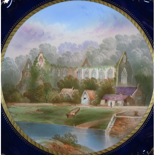 693 - A Victorian Minton china wall-plate painted with 'A View in The Vale of Llangollen' (title on revers... 