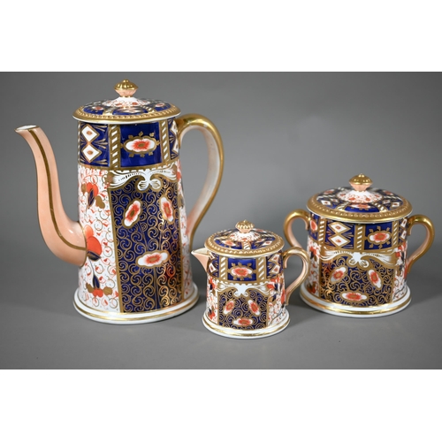 694 - A Davenport coffee pot with cream and sugar pair, decorated in the Crown Derby Imari manner, to/w fi... 