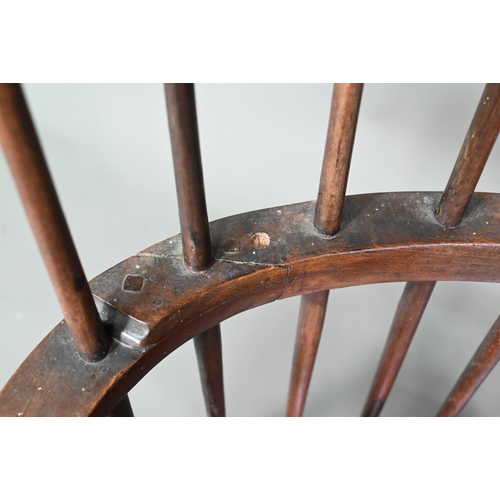 902 - An antique elm seat comb-back chair, raised on turned legs united by an H-stretcher