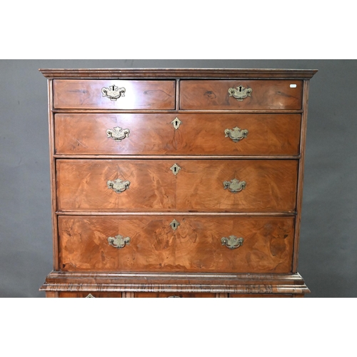 916 - A George III feather-banded walnut chest on stand, composed of two short over three long graduated d... 