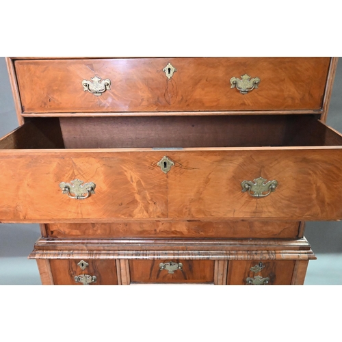 916 - A George III feather-banded walnut chest on stand, composed of two short over three long graduated d... 