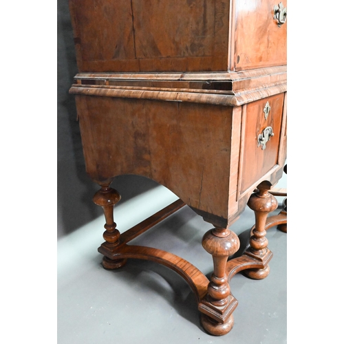 916 - A George III feather-banded walnut chest on stand, composed of two short over three long graduated d... 