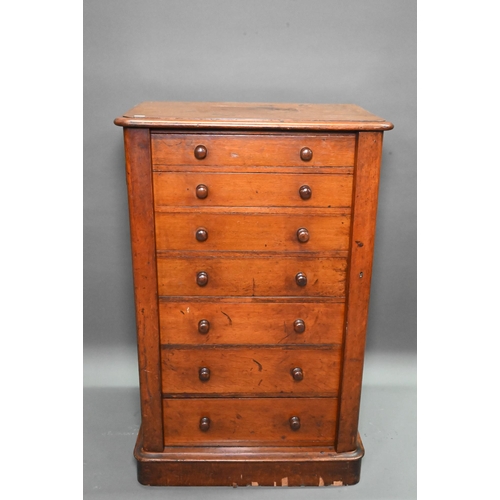 919 - A Victorian mahogany Wellington chest of seven graduated drawers, with turned handles, raised on a p... 