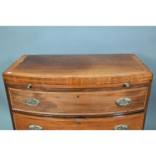 928 - A Victorian mahogany bow-fronted chest of three drawers beneath a full width slide, raised on shaped... 