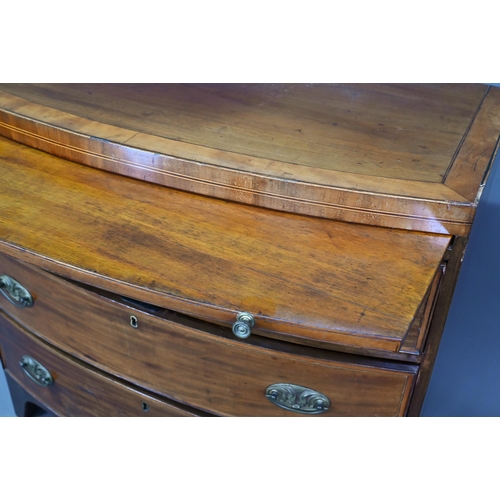 928 - A Victorian mahogany bow-fronted chest of three drawers beneath a full width slide, raised on shaped... 