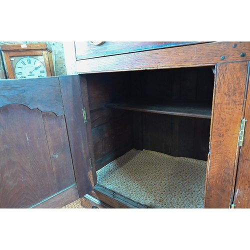 929 - An 18th century oak and elm low dresser base with three drawers over three fielded panel doors, with... 