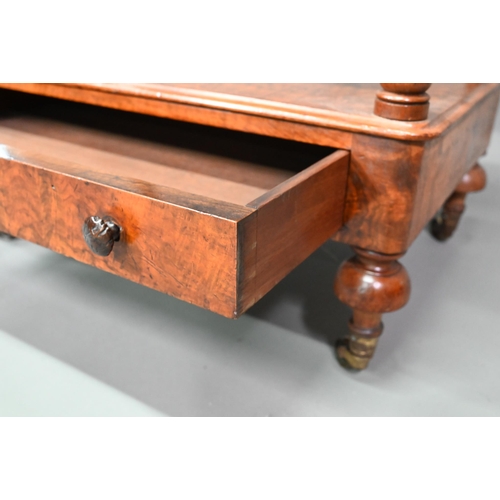 930 - A Victorian walnut three tier what-not with barley twist supports, over a base drawer, on brass cast... 