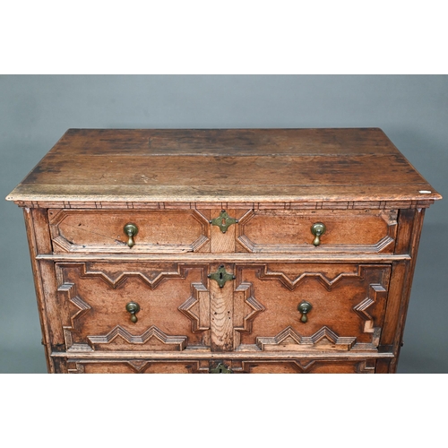 933 - A Jacobean oak chest of four long irregularly graduated drawers, with applied geometric mouldings an... 